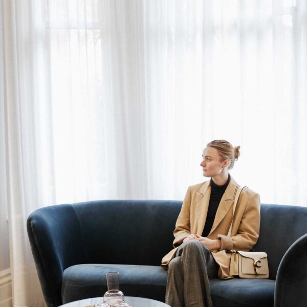 A client sitting on a sofa in the waiting room