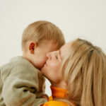 Mother kissing a child's cheek