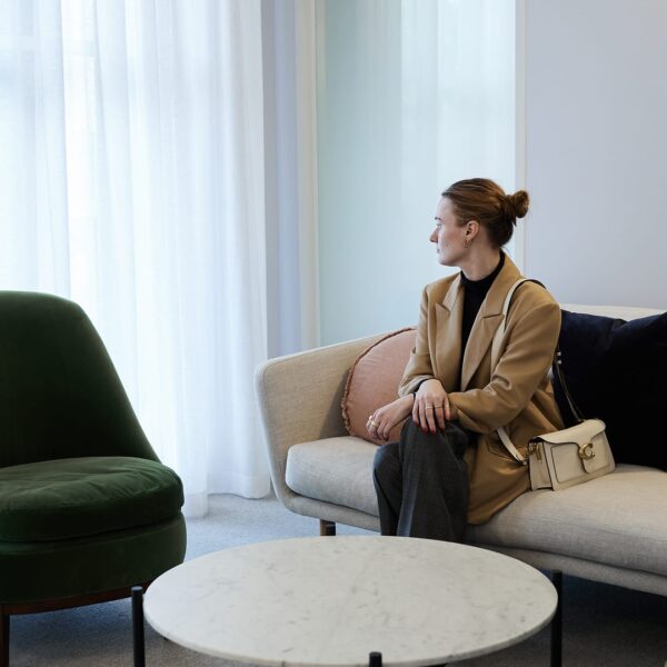 A client sitting on a sofa in the waiting room