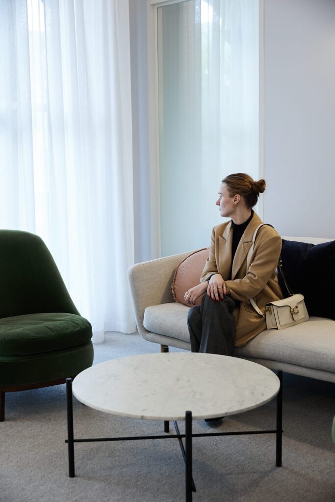 A client sitting on a sofa in the waiting room