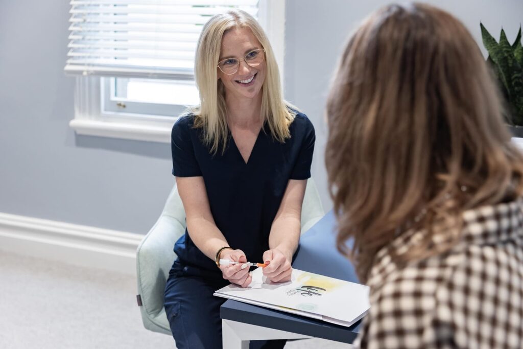 clinician sitting down speaking with a client