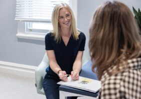 clinician sitting down speaking with a client