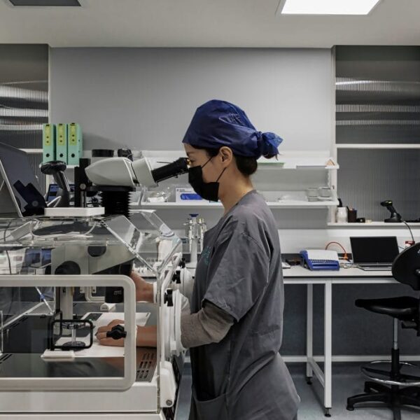 Lab technician using a lab equipment while standing up