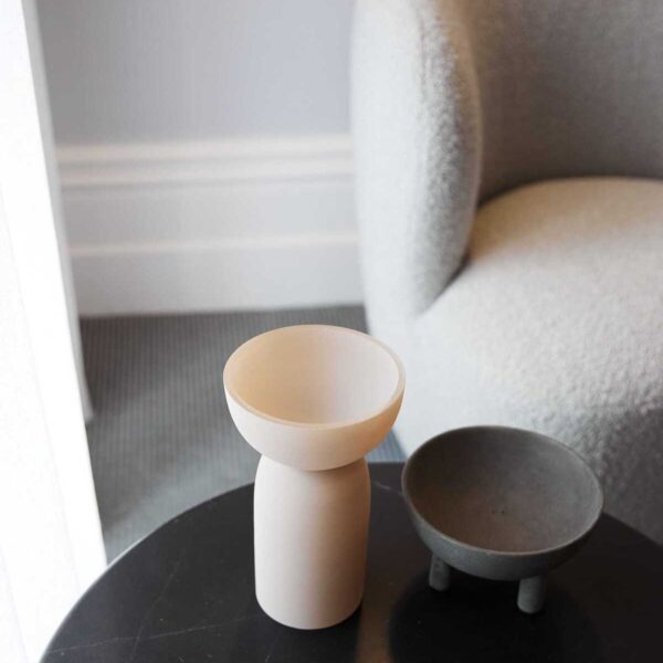 Decorative cup-like objects sitting on top of a side table in a waiting room
